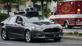 Automated vehicle prototype with San Francisco FD ambulance in background